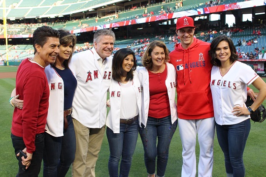 communications alumna throws first pitch at angel game